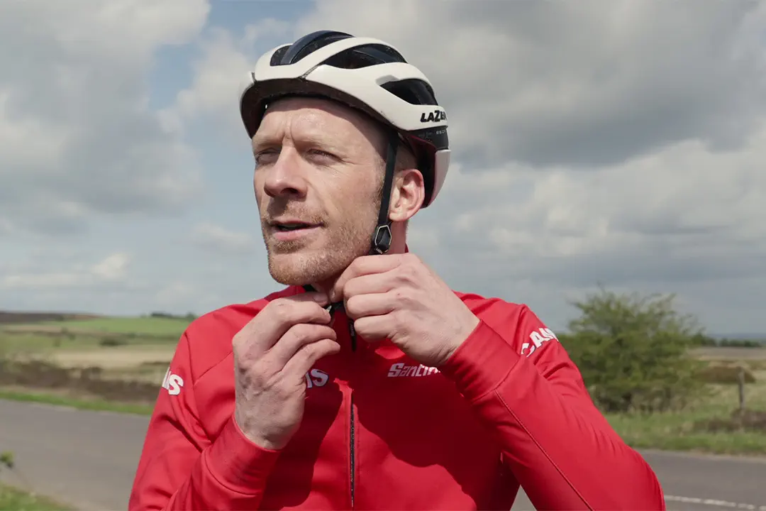 Ed Clancy OBE attaching cycling helmet